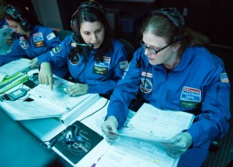 Sally Mitchell (right), from Pine Grove Middle School, with Team Zarya during a mission at Honeywell Educators at Space Academy.