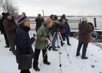 Paul Richardson (left) of Onondaga Audubon Society sets up a scope to help spot birds. Sue Fillinger (center) of Pompey sees a Great Black-backed Gull on the lake.