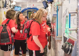 Heather Bermingham  (right), from Westside Academy at Blodgett, in the Science on Orbit exhibit at the U.S. Space & Rocket Center.