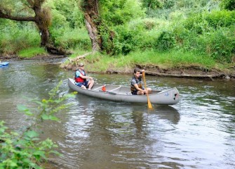 Scott (left) and Sam Stearns, from Marietta, navigate down a healthier Nine Mile Creek.