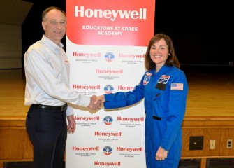 John McAuliffe, Honeywell Syracuse Program Director, congratulates teacher Katherine Clift at Camillus Middle School on receiving a scholarship to attend Honeywell Educators at Space Academy.