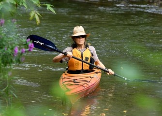 Ruth Florey, Onondaga Lake Conservation Corps member, observes the diverse flora and bird life along Nine Mile Creek, a major tributary to Onondaga Lake.