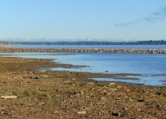 The rock berms will decrease wave action along the shoreline, reducing erosion.