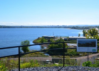 A view of the Onondaga Lake Visitors Center (center) and the City of Syracuse (background) from Onondaga County’s West Shore Trail.