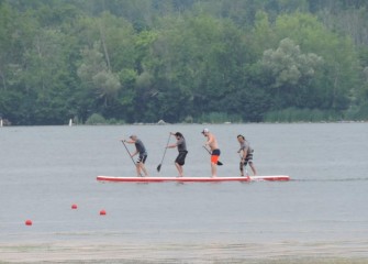 A dragon board, or four-person paddleboard, team practices before races.