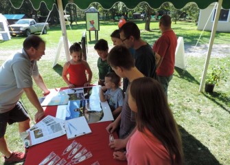 Visitors stopping at the Honeywell booth learn more about fish species returning to Onondaga Lake.