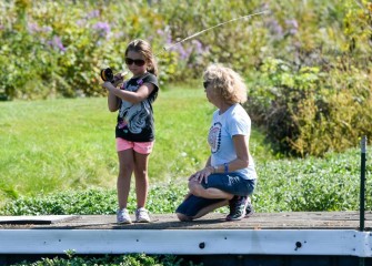 Nancy Lobello, member of the Iroquois Chapter of Trout Unlimited, teaches 7-year-old Saree Weed, of Moravia, to fly fish.