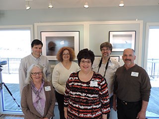This year's exhibit featured seven local photographers pictured left to right (front row): Cheryl Lloyd, Michele Neligan, and Phillip Bonn; (back row): Greg Craybas, Diana Whiting, and John DeNicola. Not pictured: John Savage.