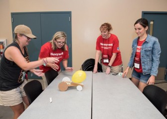 Erin Emanuele (right) and colleagues test a balloon air propulsion model vehicle. HESA teachers are provided hands-on lessons and exercises they can bring back to their classrooms.
