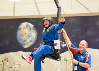 Michelle Hall in the 1/6th gravity chair at the U.S. Space & Rocket Center.