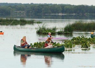 Taylor Jones, of Baldwinsville, shoots photos of water lilies in bloom.  The water lilies were Taylor’s “favorite” on the paddle, along with “all the birds.”