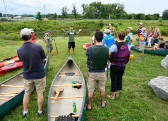 Montezuma Audubon Center Director Chris Lajewski (center) welcomes participants, explains the paddle route and describes what the group can expect to see.