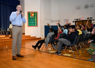 Honeywell Syracuse Program Director John McAuliffe speaks at J.T. Roberts PreK-8 School in the Syracuse City School District at a HESA recognition ceremony.