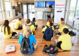 Inside the Onondaga Lake Visitors Center, students observe microscopic organisms in a lake water sample projected onto a screen (left). The health, abundance and diversity of microscopic organisms are indicators of the health of an ecosystem.