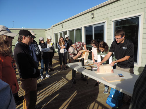 Tom Hughes (right), Natural Resource Steward Biologist with New York State Parks, Recreation and Historic Preservation, demonstrates how to construct bird boxes.  “We at New York State Parks are committed to conservation efforts within our communities,” said Hughes. “Constructing and installing bluebird nesting boxes is one way we can all work together to create or enhance habitat for New York’s official state bird.”