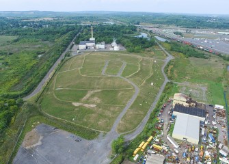 Before placement of the cap, remediation included mercury removal, excavation of contaminated soil, installation of a groundwater collection system, and construction of an underground cutoff wall.