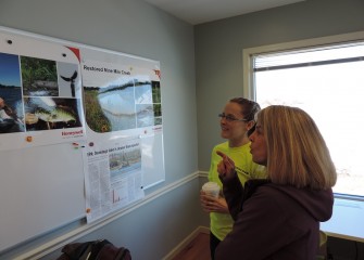 Barbara Johnson (right), of DeWitt, New York, learns about improvements at Onondaga Lake and nearby tributaries that are providing restored habitat for wildlife from Anne Burnham, a habitat expert from Parsons.