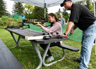 Sixteen-year-old Elise Dougherty, of Liverpool, learns how to use a crossbow from Onondaga County Parks Commissioner Bill Lansley.