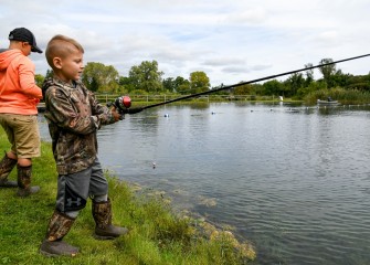 Brothers Colton (left) and 5-year-old Jaxen Munson, of Jordan, fish for trout in the public pond at Carpenter’s Brook Fish Hatchery.