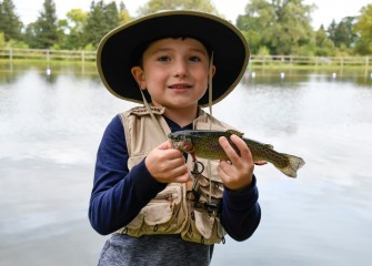 Six-year-old Grayson LaGrow, of Skaneateles, holds a trout caught in the public fishing pond at Carpenter’s Brook Fish Hatchery.