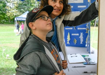 David Hoovler, age 8, of Syracuse, identifies birds with Onondaga Lake Conservation Corps Coordinator Sue Potrikus.