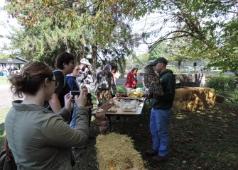 Lucas Whitman (right) of Onondaga County Parks allows visitors to get a close-up look at a Eurasian Eagle Owl at the display hosted by the Rosamond Gifford Zoo.