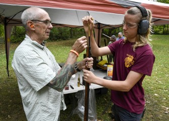 Vincent Franklin (right), from North Carolina in Central NY visiting relatives, loads the muzzle of a rifle with guidance from Dennis MacVittie of Lock Stock & Barrel Club in Volney, NY.  Muzzle-loaded firearms are used for hunting, sport, and by collectors interested in history.