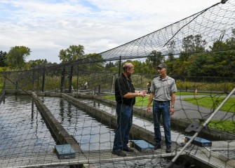 John McAuliffe (right), from Honeywell, is given a tour of the trout ponds at Carpenter’s Brook Fish Hatchery by Onondaga County Parks Commissioner Bill Lansley.