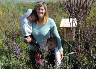 Bridget Sunkes, of East Syracuse, with children Eleanor and Holden, by the bird nesting box they helped build and place in restored habitat near Onondaga Lake.