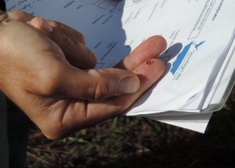 Tom Hughes, Natural Resource Steward Biologist with New York State Parks, Recreation and Historic Preservation, holds a tiny snail on his fingertip while explaining how to tell a gilled snail from a lunged snail.