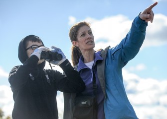 Liam Adams (left), 13, and mom Heather Adams, of Cicero, track native birds along the western shoreline of Onondaga Lake.