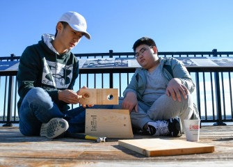 Jeffrey (left) and Peter Wang, of Manlius, assemble a bluebird nesting box on the deck at the Onondaga Lake Visitors Center.