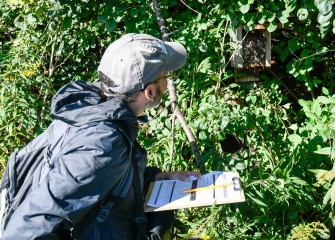 Volunteers take part in citizen science monitoring. Rich Jarrett, of Liverpool, opens, inspects and records the contents of a previously installed nesting box along the Western Shoreline. After, the box is cleaned out for use by birds next breeding season.