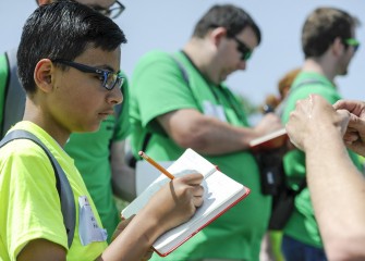 Ahmed Fakhr, from Ihsan School of Excellence, records notes in his field guide.