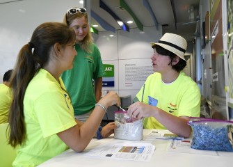 Joanna Hanson (left), from Christian Brothers Academy, and Holden Leonard, from Camillus Middle School, discuss what they notice so far with science counselor Visma Leimanis.