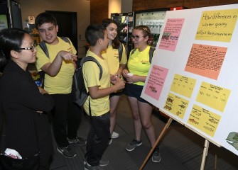 Parents visit the poster session on Discovery Day, the last day of the Honeywell Summer Science Week program.